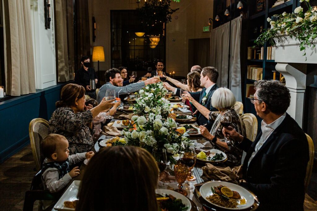 a group of people sitting around a long table