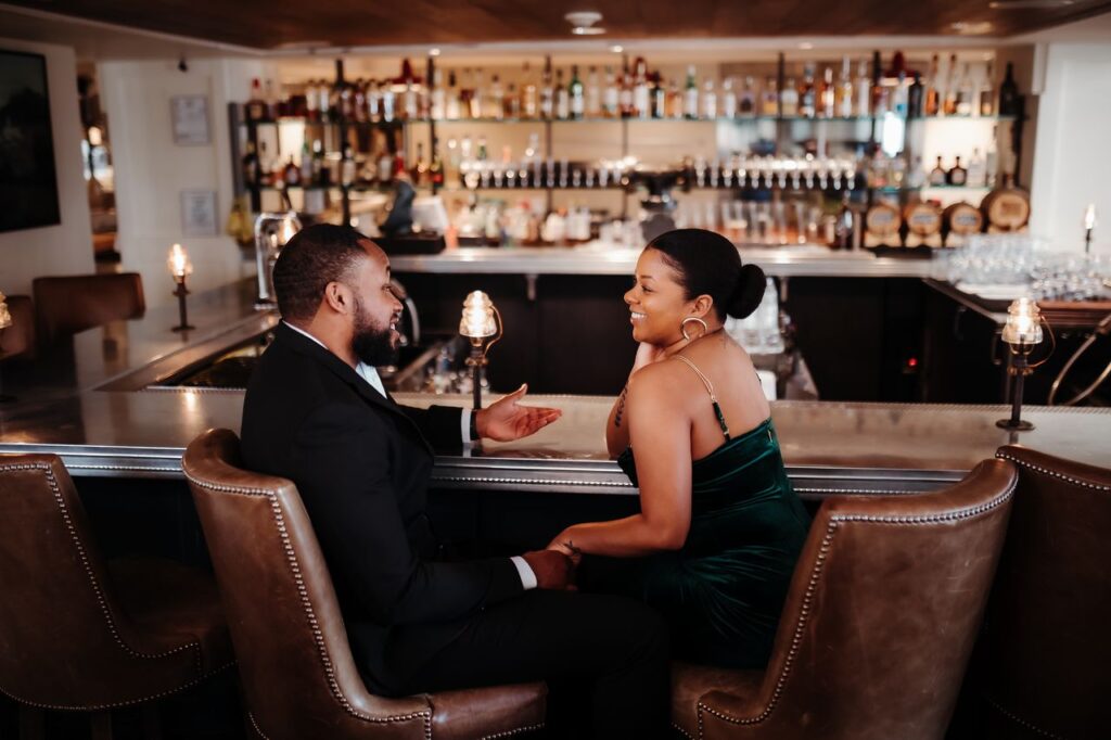 a man and a woman sitting at a bar