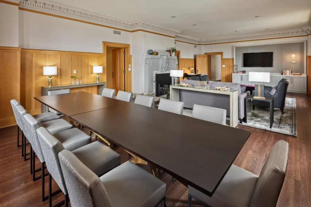 a long table with chairs and a television in a room