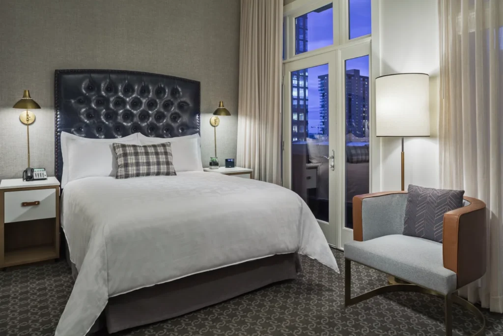 a bedroom with a large bed and a chair