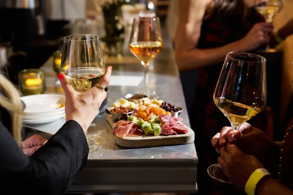 a group of people sitting at a table with wine glasses