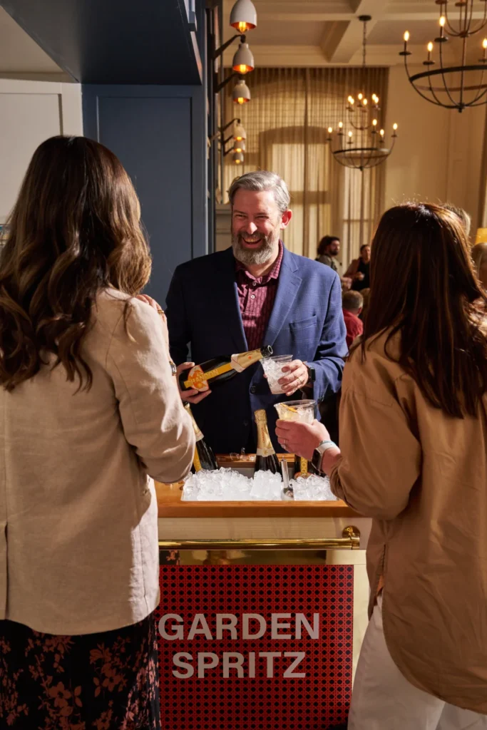 a group of people standing around a table