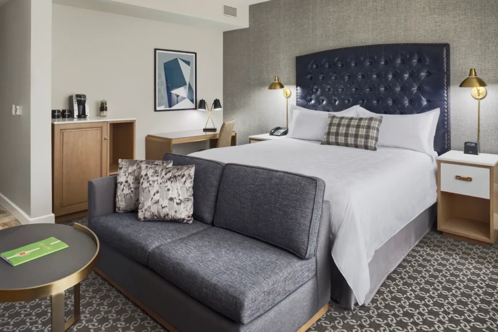 a hotel room with a bed and a couch