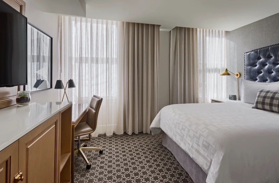 a bedroom with a large bed and a flat screen tv