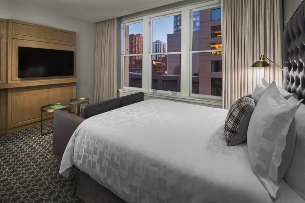 a hotel room with a large bed and a flat screen tv