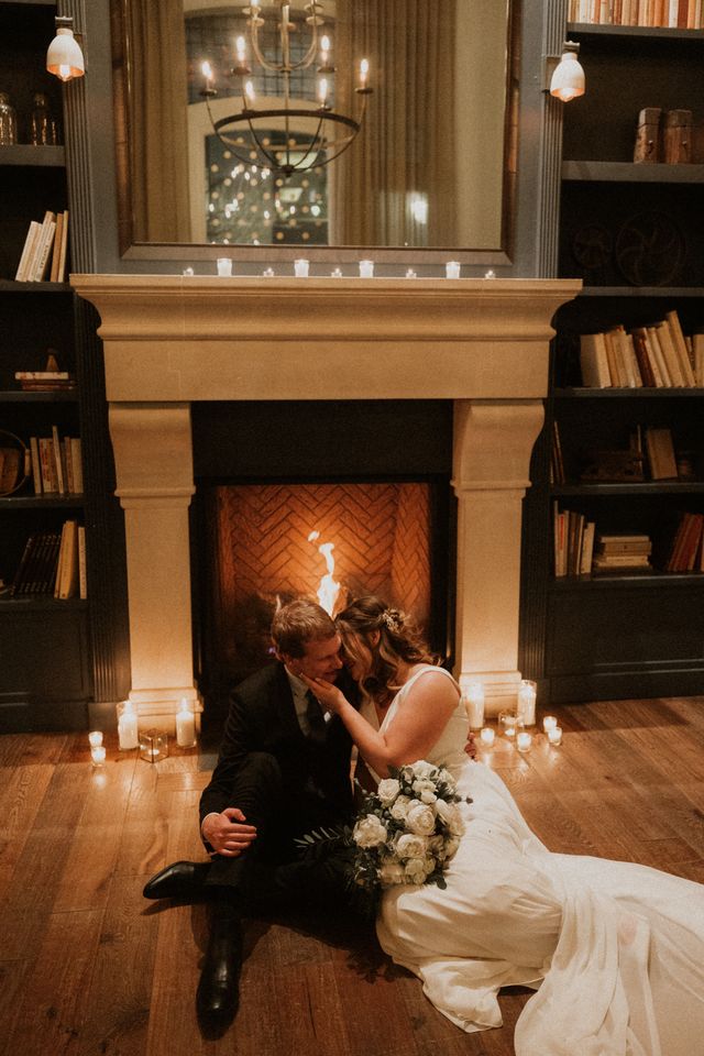 couple in love sitting by a lit fire, romance