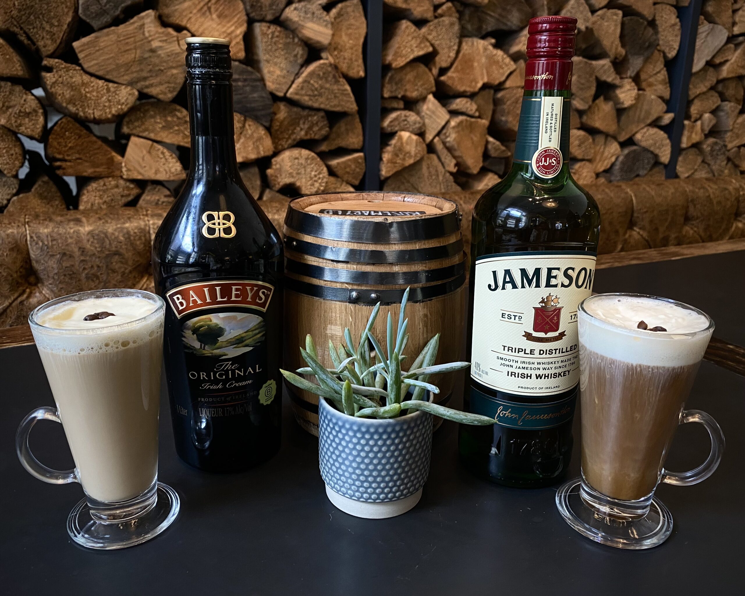 irish coffees next to bottles of jameson and baileys