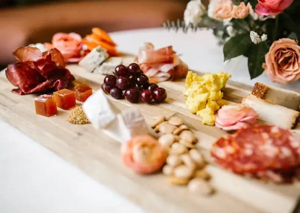 a wooden cutting board topped with different types of food