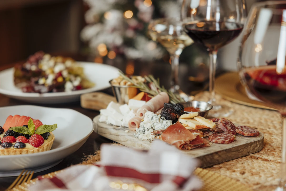 a table topped with plates of food and glasses of wine