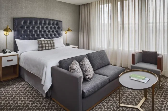 a hotel room with a bed and a couch
