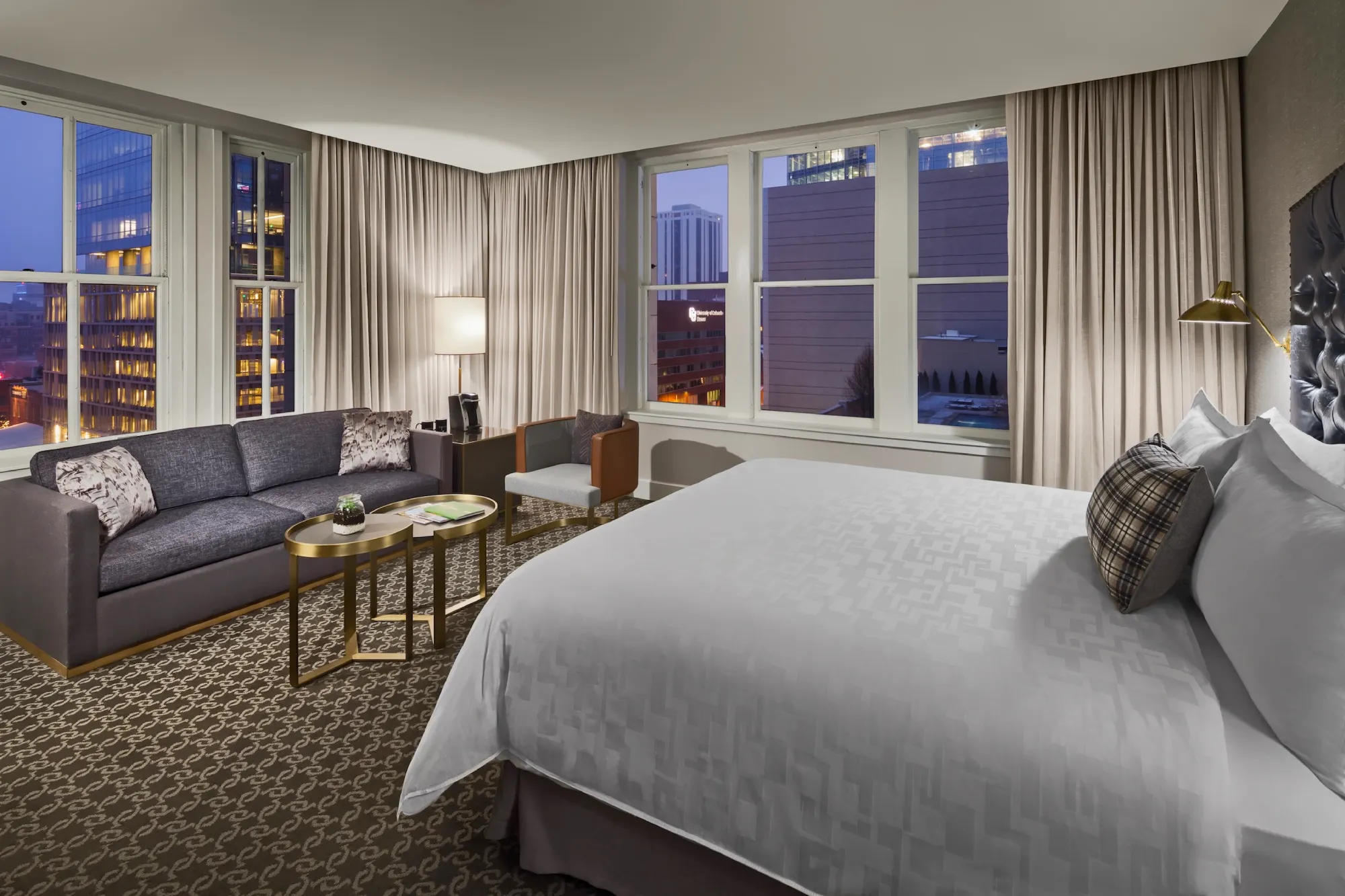 a hotel room with a large bed and a couch