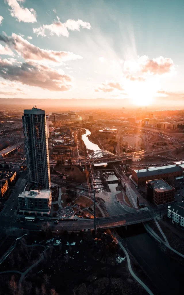 an aerial view of a city at sunset